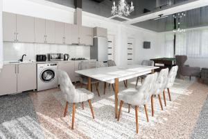 a kitchen with a table and chairs in a room at Mtirala Panorama in Khala