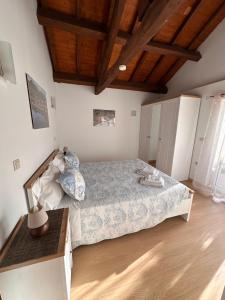a bedroom with a bed and a wooden floor at Chalé da Fonte - T2 in Geres