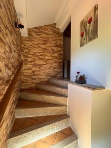 a staircase in a house with a brick wall at Chalé da Fonte - T2 in Geres