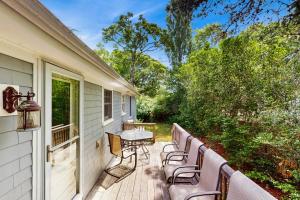 a deck with chairs and a table on a house at Winthrop Cottage in Oak Bluffs