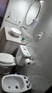 a bathroom with a toilet and a sink and a mirror at Apartamento Molina 2 in Mendoza