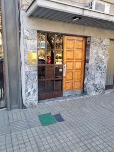 a door of a building with a green rug in front at Apartamento Molina 2 in Mendoza +1 photo