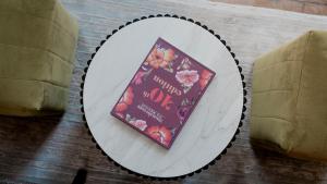 a book sitting on a plate on a table at Casa Bonita Hotel & Luxury Residence in Oaxaca City +67 photos