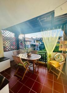 a room with a table and chairs on a balcony at Sea&Sage 4 Spiagge Raggiungibili a piedi, Per famiglie con tutti i servizi in Porto San Paolo