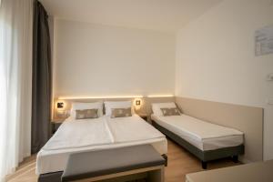 Posteľ alebo postele v izbe v ubytovaní Hotel Delfino