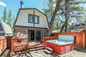a small house with a hot tub on a deck at Little Brown Bear - Beautiful view, quiet area and an amazing hot tub! in Big Bear Lake