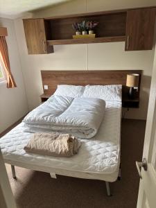 a bed with two pillows on it in a room at The Bay Pearl 2 Bedroom Elegant Pet Free Stay at Clarach in Aberystwyth