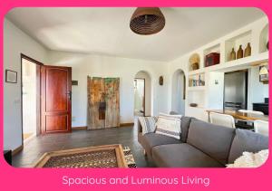 a living room with a couch and a table at Full Relaxation - Private Villa - Sea View - Stunning Garden - 2 Terraces - 2 Bedrooms - Wifi - Parking - Washing Machine in Güime +30 photos