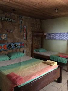 Cama ou camas em um quarto em Pousada Alquimia