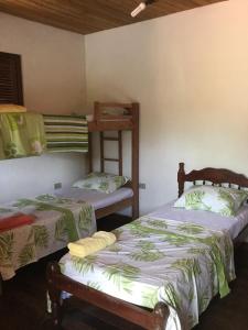 Cama ou camas em um quarto em Pousada Alquimia