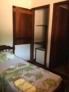 Cama ou camas em um quarto em Pousada Alquimia