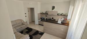 a kitchen with a couch and a chair in a room at Hice Room Lungomare Fronte Mare in Catanzaro