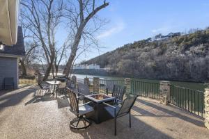 a patio with chairs and a table next to a river at Foggy River Retreat - For 16 in Hollister
