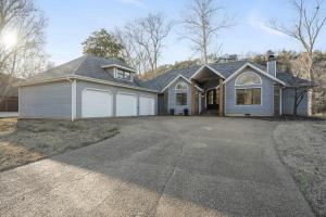 a house with a garage and a driveway at Foggy River Retreat - For 16 in Hollister