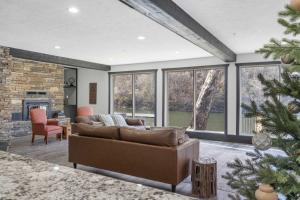 a living room with a couch and a christmas tree at Foggy River Retreat - For 16 in Hollister +40 photos