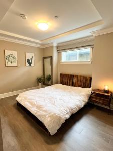 a bedroom with a large bed and a window at 3Bed 2Bath Steam Sauna Retreat! Family friendly! in Vancouver