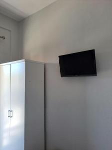 a flat screen tv hanging on a wall at Eleni's seaside home in Asprovalta