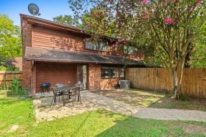 a house with a table and chairs in the yard at Minutes from Tiger Stadium South Campus Hideaway in Baton Rouge