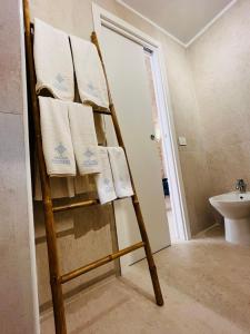 a towel rack in a bathroom with towels on it at Relais Macramè in Manfredonia +27 photos