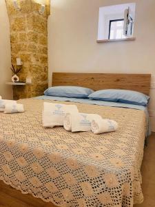 a bedroom with a bed with two towels on it at Relais Macramè in Manfredonia