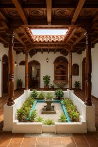 a courtyard with a fountain in the middle of a building at SGH Hotel San Agustin in Santa Marta