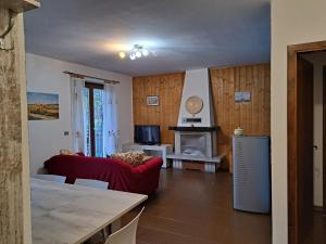 a living room with a red couch and a fireplace at Oasi Pieve in Pian di Scò