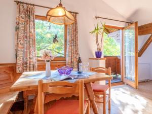 a dining room with a table and chairs and a window at Appartement Brixnerwirt IV in Brixen im Thale +19 photos