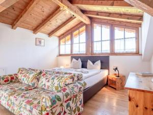 a living room with a couch and a bed at Appartement Brixnerwirt IV in Brixen im Thale