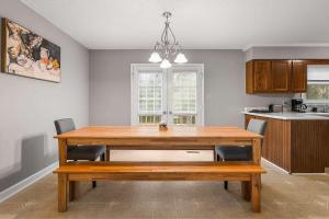 a dining room with a wooden table and chairs at Near Parks Trails & Downtown Raleigh Retreat in Raleigh +32 photos