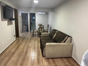 a living room with a couch and a television at Casa Alto da Glória in Curitiba