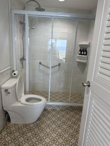 a bathroom with a toilet and a shower at Patong13 in Ban Bang Khu