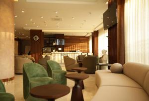 a lobby with a couch and chairs and a bar at Tress Hotel in Istanbul