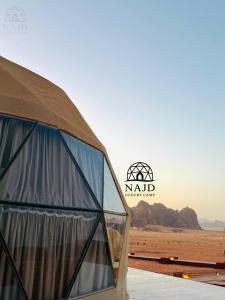 a domed building with a view of the desert at Wadi Rum NAJD Luxury Camp in Wadi Rum