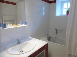 a white bathroom with a sink and a bath tub at Maison de campagne avec grande terrasse, près de Lavaudieu et accessible PMR - FR-1-582-217 in Mazerat-Aurouze