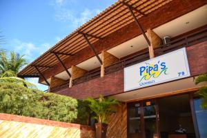 a sign on the side of a building at Pipas Ocean by Pipa Centro in Pipa +61 photos
