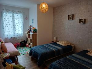 a small bedroom with two beds and a window at Appartement au coeur de Cours La Ville in Cours la Ville +28 photos