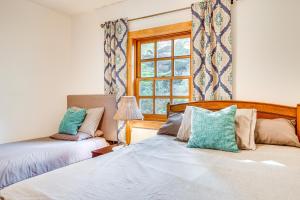 a bedroom with two beds and a window at Salmon Return and Wildlife Roam Ketchikan Getaway! in Ketchikan
