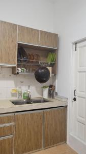 a kitchen with a sink and a counter top at Homestay H&H in Cyberjaya