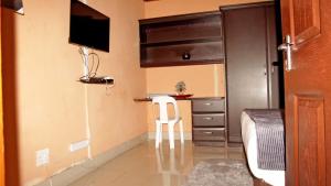 a small room with a bed and a small kitchen at A2B Lodge in Durban