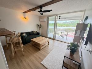 a living room with a couch and a table at Appartement COSY SXM in Cul de Sac