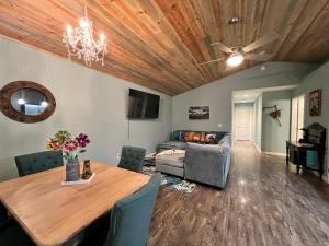a living room with a table and a couch at Forest cottage - secluded, hot tub, walk to beach in Rockaway Beach