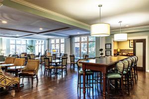 a restaurant with tables and chairs and windows at Hampton Inn Charleston-Daniel Island in Charleston