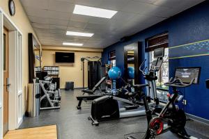 a gym with cardio equipment and a blue wall at Hampton Inn Charleston-Daniel Island in Charleston