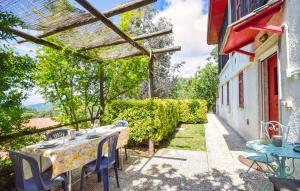 a patio with a table and chairs outside of a building at Cozy Home In Deiva Marina With Wifi in Deiva Marina +17 photos