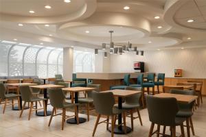 a restaurant with tables and chairs and a chandelier at Hampton Inn Hopewell Fort Gregg-Adams in Hopewell