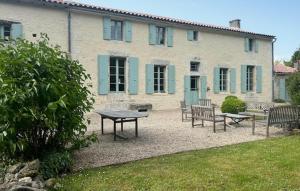 a patio with benches and a table in front of a building at Gorgeous Home In Geay in Geay +31 photos