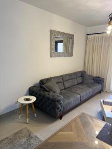 een woonkamer met een bank en een tafel bij 1 Bedroom at Marassi Marina in El Alamein