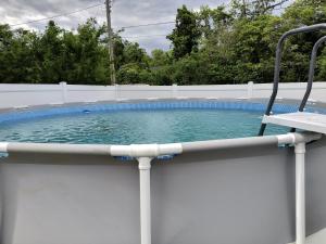 a swimming pool with a chair on a fence at My Cozy Beach House Cape May Court House NJ Pool Near Wildwood and Cape May in Whitesboro