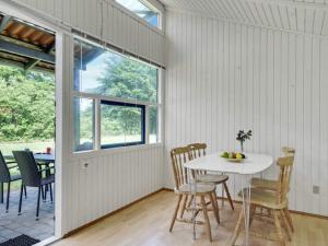 a dining room with a white table and chairs at 4 person holiday home in Hampen in Hampen +31 photos
