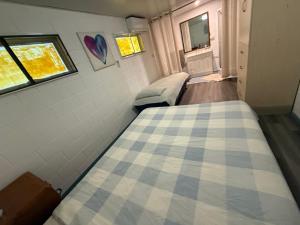 a small room with a bed and a window at Comfortable studio in Bowen 4805 in Bowen